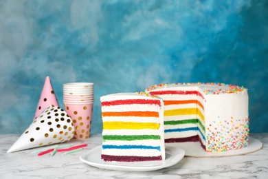 Photo of Delicious rainbow cake for party on table