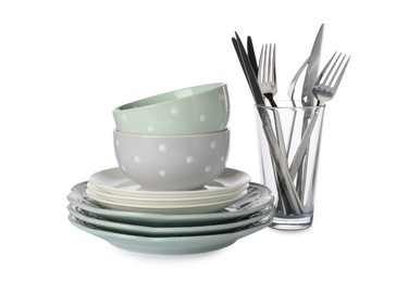 Set of beautiful ceramic dishware, glass and cutlery isolated on white