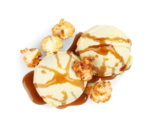 Photo of Delicious ice cream with caramel popcorn and sauce on white background, top view