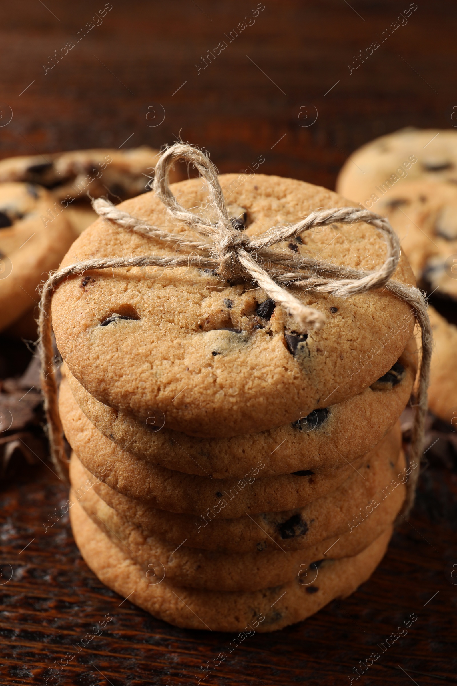 Photo of Delicious chocolate chip cookies on wooden table