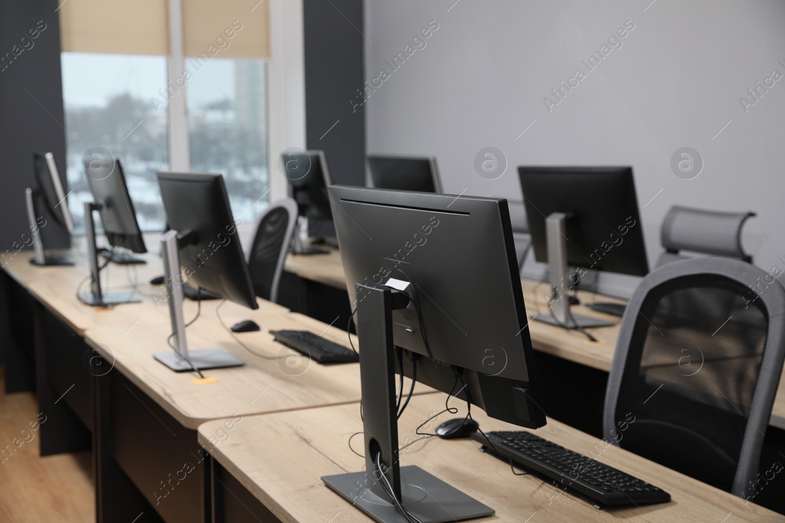 Photo of Many modern computers in open space office