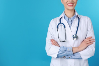 Young medical student in uniform on color background, closeup. Space for text