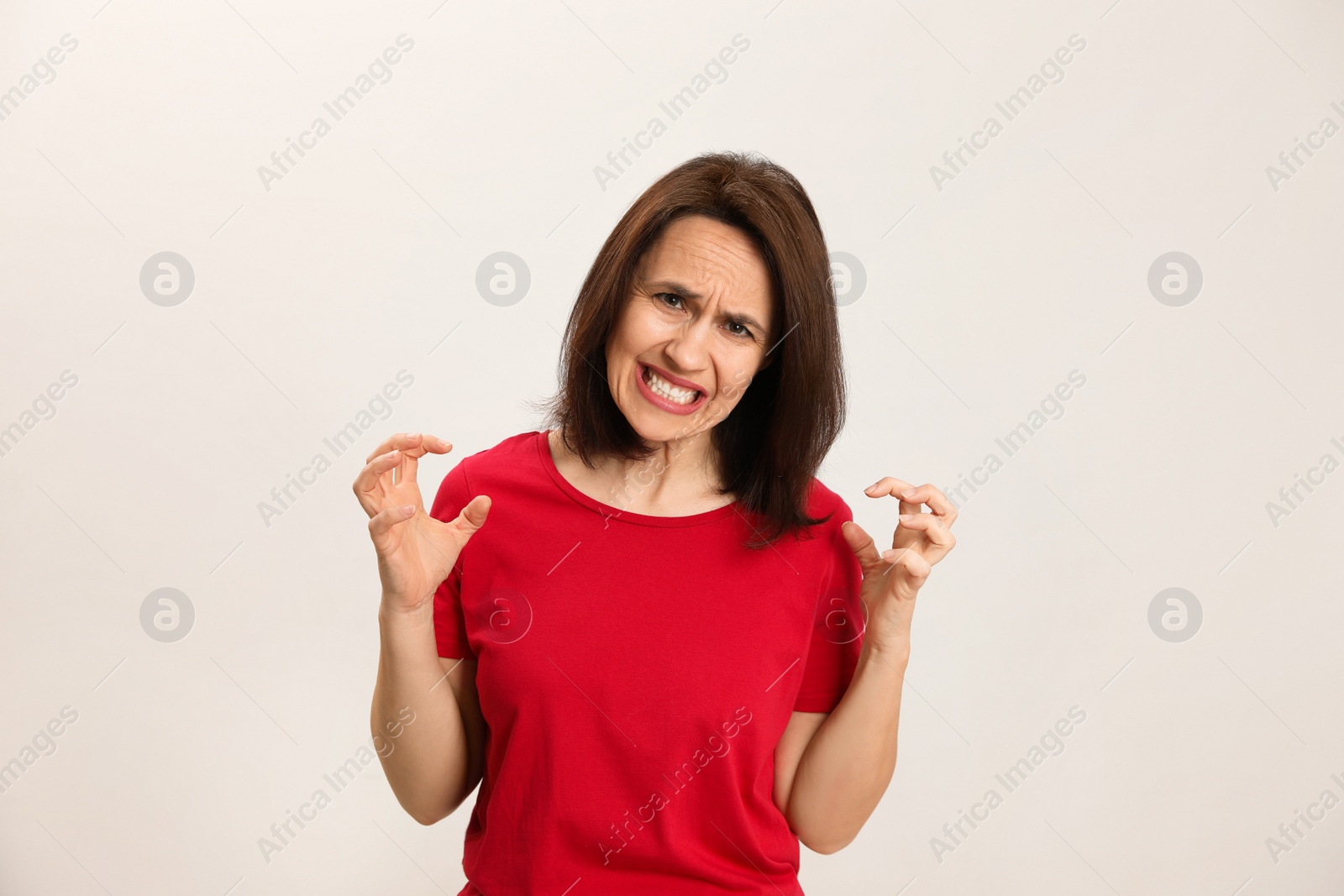 Photo of Portrait of woman filled with hate on light  background