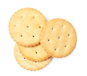 Many crispy crackers isolated on white, top view. Delicious snack