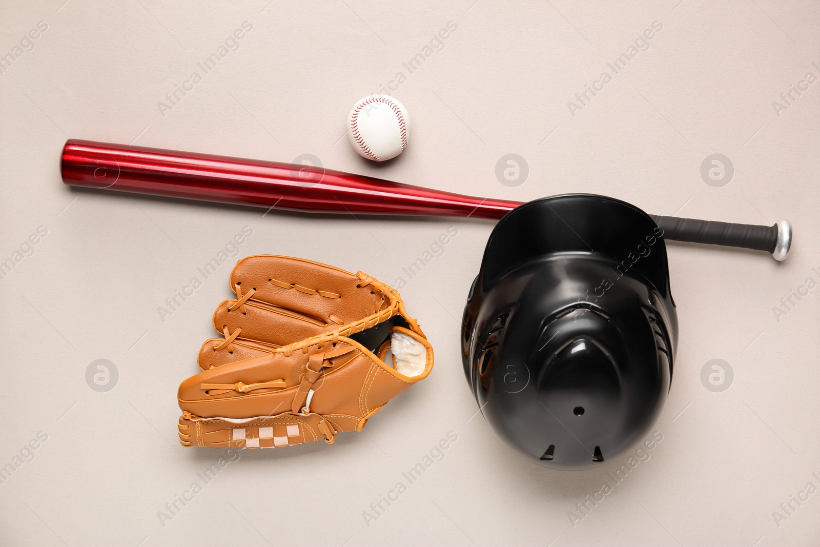 Photo of Baseball glove, bat, ball and batting helmet on light grey background, flat lay