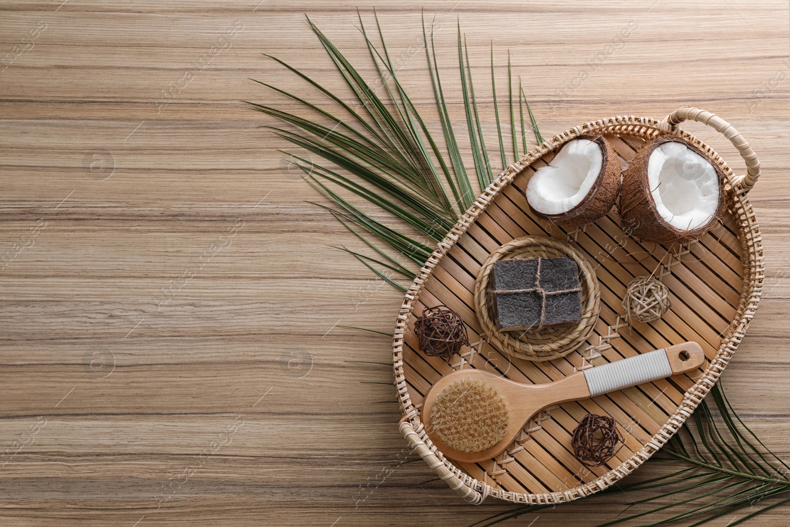 Photo of Flat lay composition with handmade soap on wooden background. Space for text