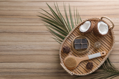 Photo of Flat lay composition with handmade soap on wooden background. Space for text