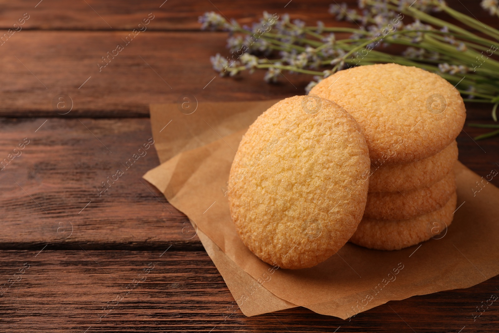 Photo of Delicious Danish butter cookies on wooden table, closeup. Space for text