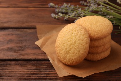 Photo of Delicious Danish butter cookies on wooden table, closeup. Space for text