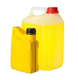 Photo of Yellow canisters with liquids on white background