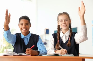 Teenage students in classroom. Stylish school uniform