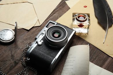 Photo of Composition with different vintage items on wooden table. Detective's workplace