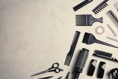 Photo of Flat lay composition with hairdresser tools on color background. Space for text