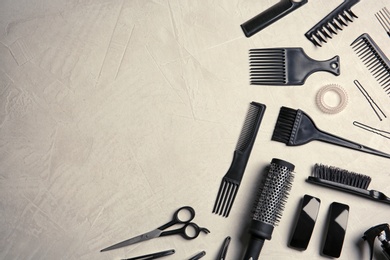 Flat lay composition with hairdresser tools on color background. Space for text