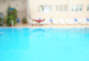 Blurred background of swimming pool with clear blue water