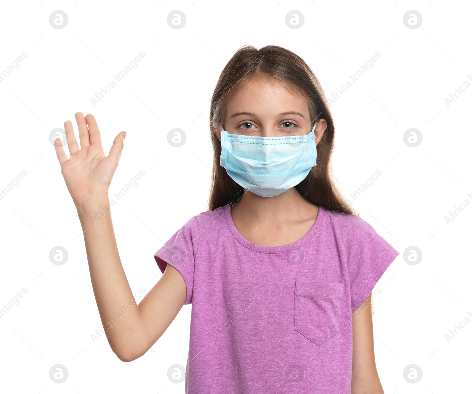 Photo of Little girl in protective mask showing hello gesture on white background. Keeping social distance during coronavirus pandemic