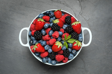 Photo of Mix of ripe berries on grey table, top view