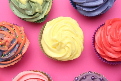 Photo of Delicious cupcake with bright cream on pink background, flat lay