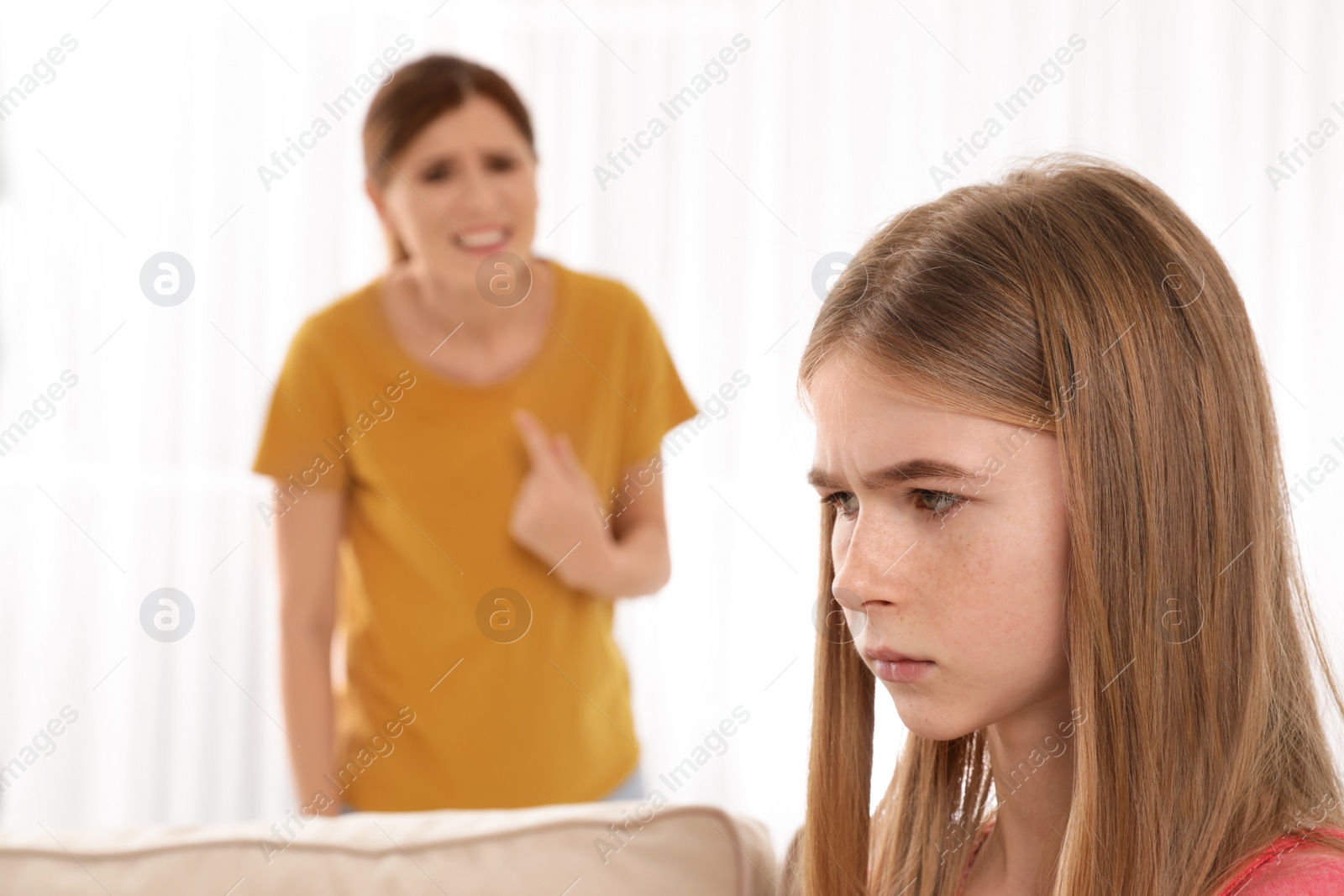 Photo of Mother scolding her teenager daughter at home