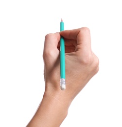 Woman drawing something with pencil on white background, closeup of hand