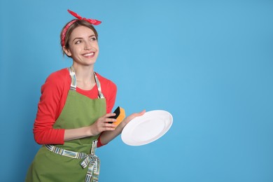 Photo of Young housewife with plate and sponge on light blue background. Space for text