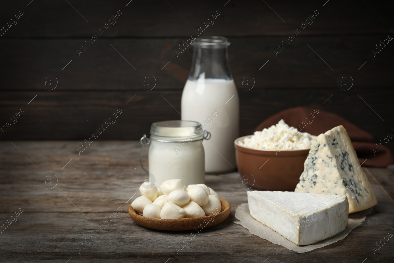 Photo of Different fresh dairy products on wooden table
