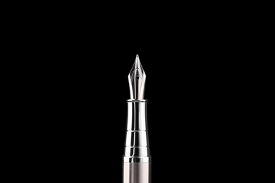 Photo of Stylish silver fountain pen on black background