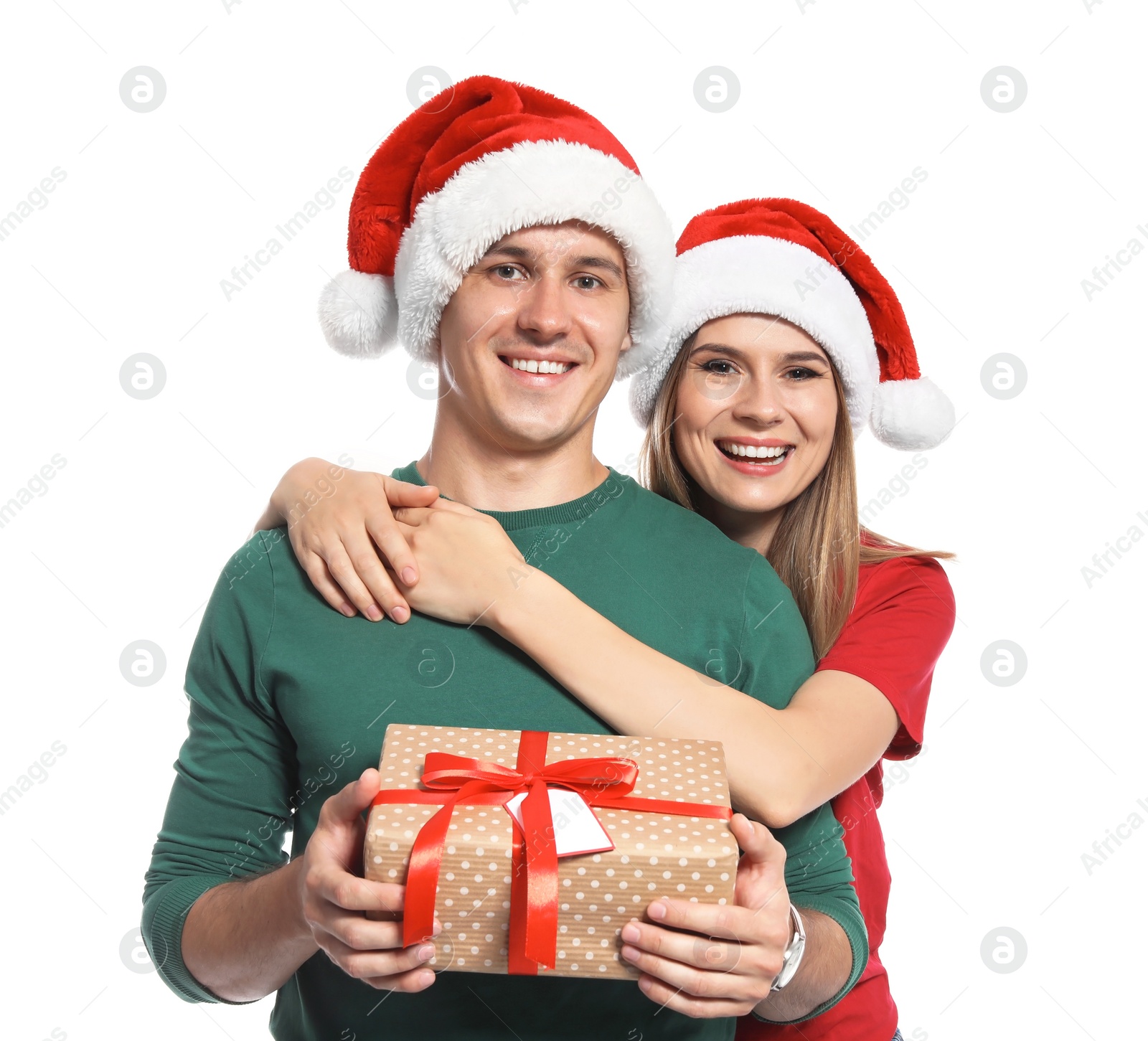 Photo of Young couple with Christmas gift on white background