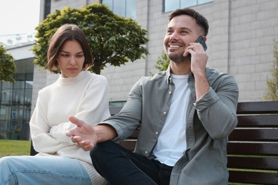 Man ignoring his girlfriend and talking on phone. Relationship problems