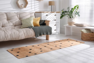 Photo of Stylish rug with dots on floor in living room