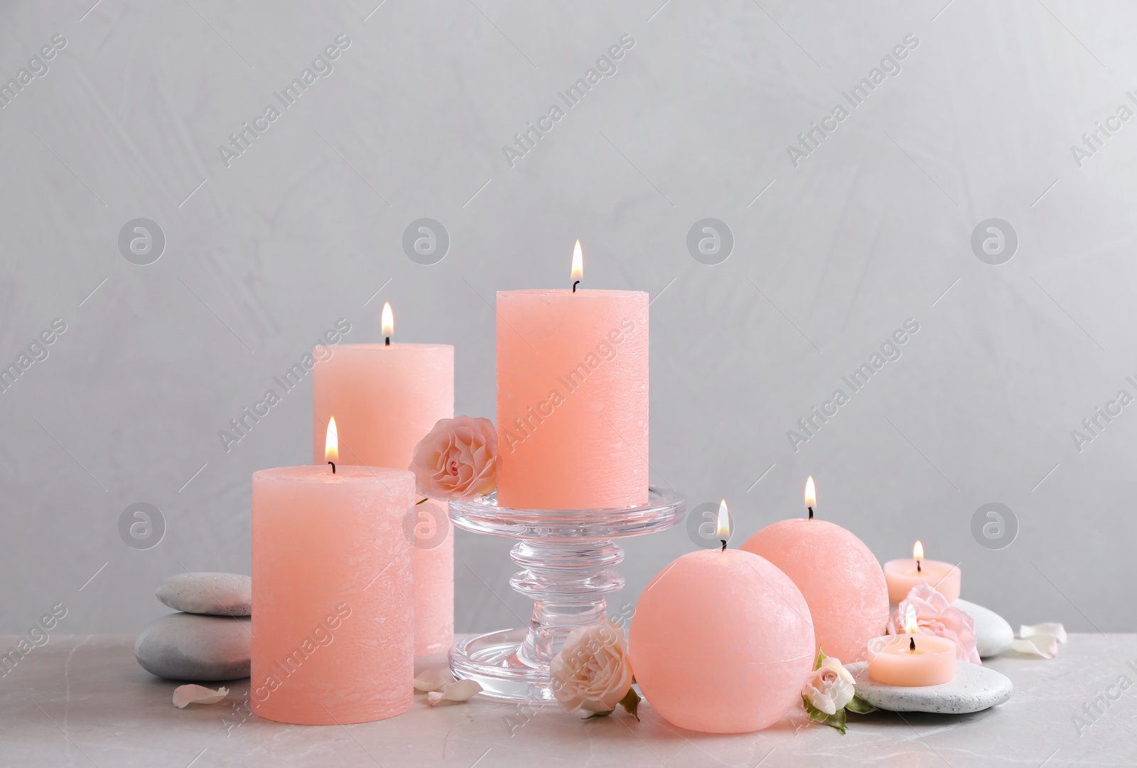 Photo of Beautiful composition with candles on table against grey background