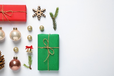 Flat lay composition with Christmas gifts and festive decor on white background