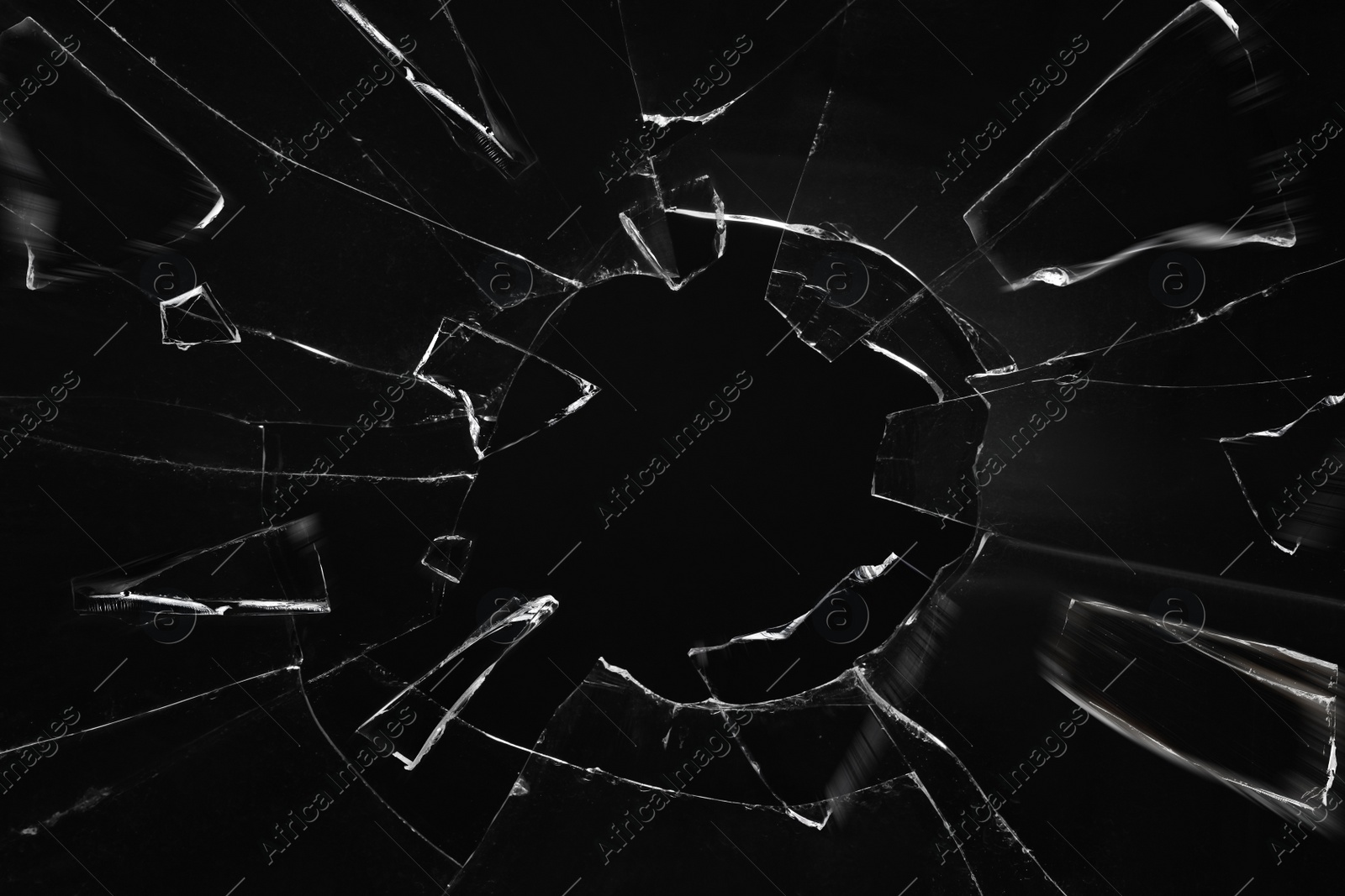 Image of Broken glass with cracks on black background