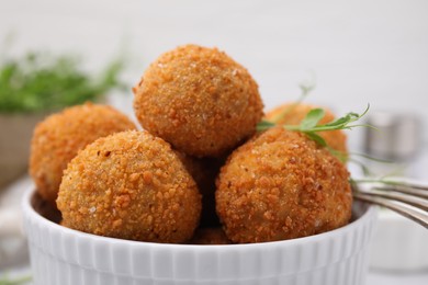 Photo of Bowl of delicious fried tofu balls with pea sprouts, closeup