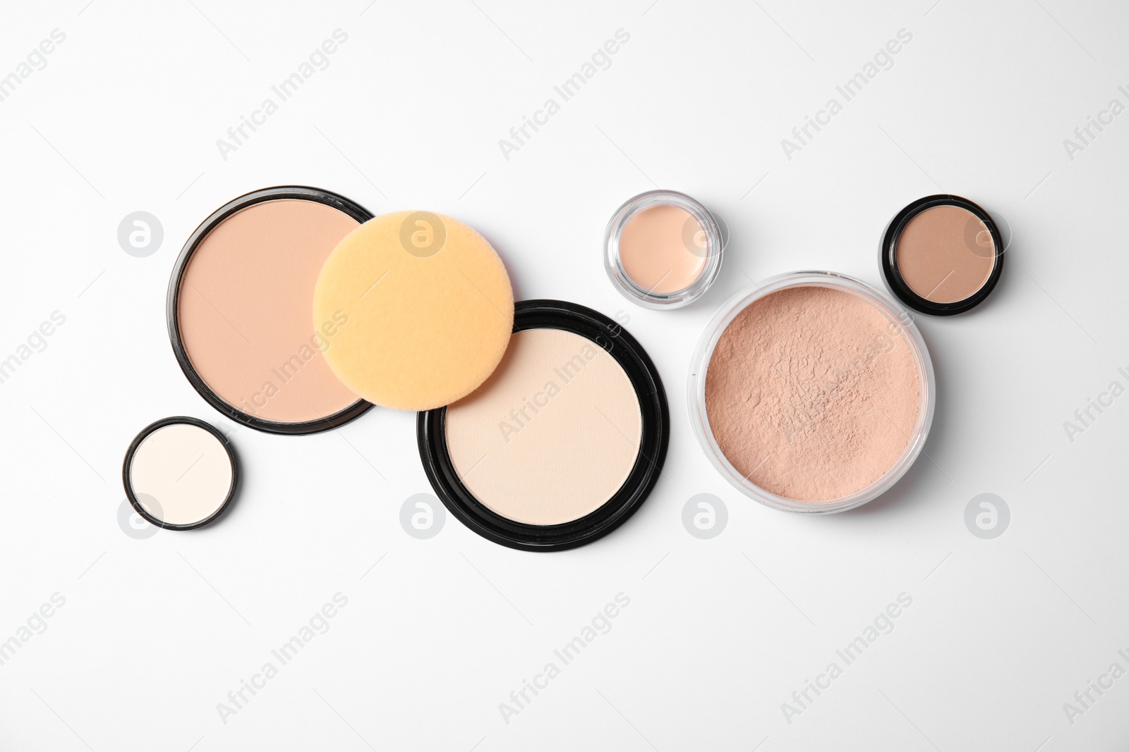 Photo of Flat lay composition with different makeup face powders on white background