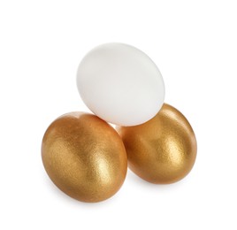 Photo of Golden eggs and ordinary one on white background