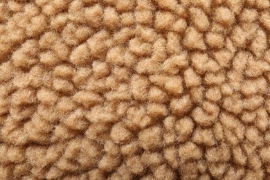 Texture of light brown faux fur as background, closeup