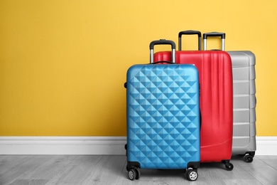 Photo of Different suitcases near color wall