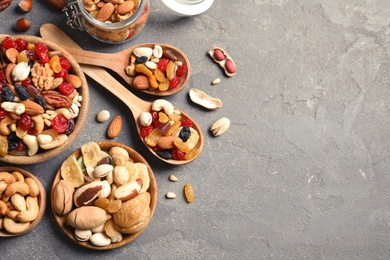 Flat lay composition of different dried fruits and nuts on color background. Space for text