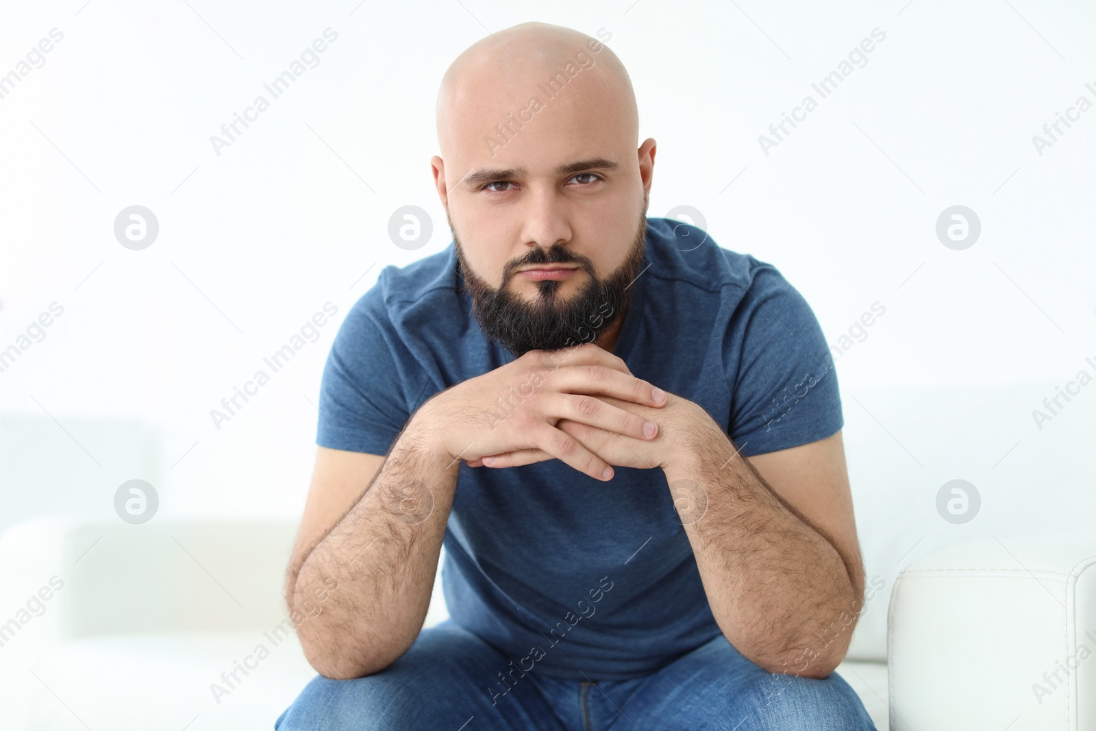 Photo of Portrait of confident young man on sofa