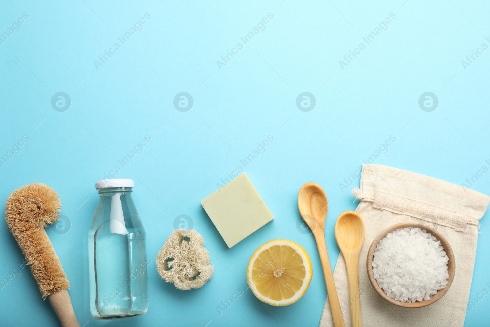 Photo of Flat lay composition with eco friendly products on turquoise background, space for text