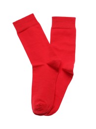 Photo of Red socks on white background, top view