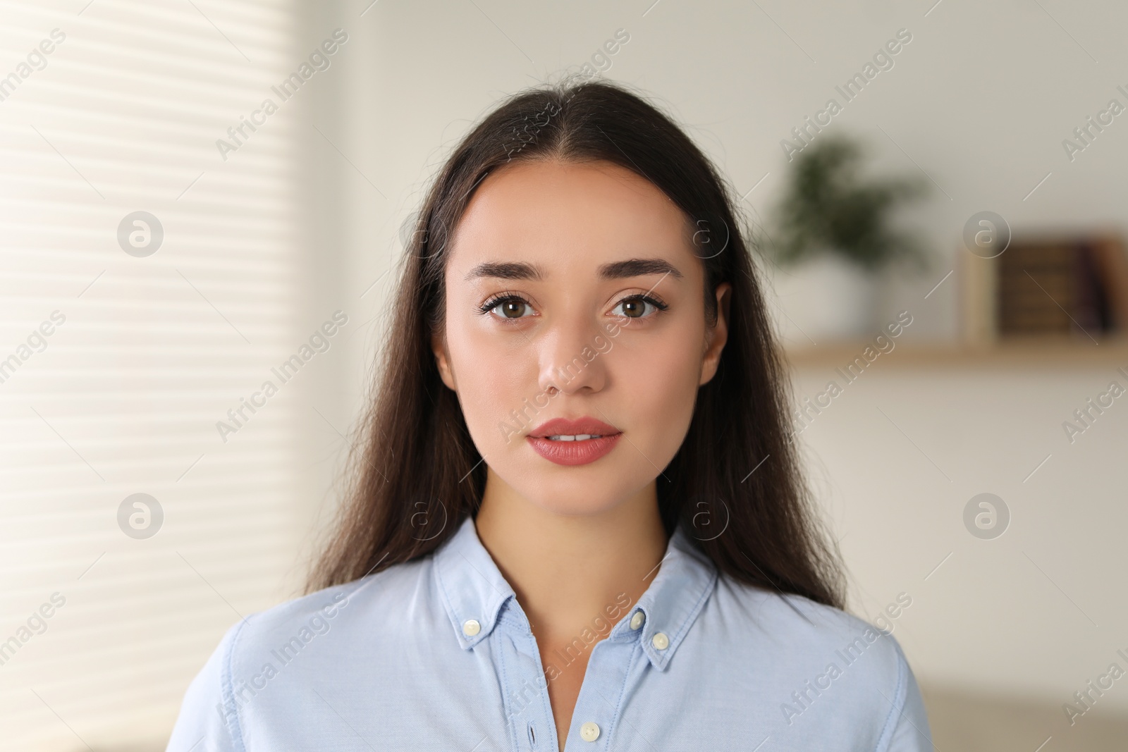 Photo of Portrait of beautiful young woman in room