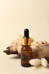 Photo of Composition with bottle of cosmetic serum on beige background