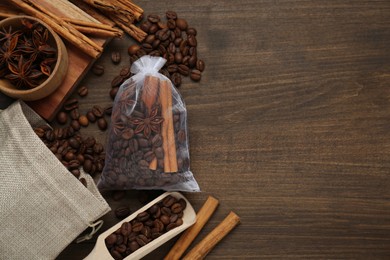 Scented sachet with coffee beans, anise and cinnamon on wooden table, flat lay. Space for text