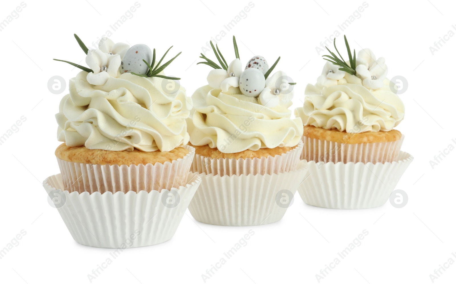 Photo of Tasty Easter cupcakes with vanilla cream isolated on white