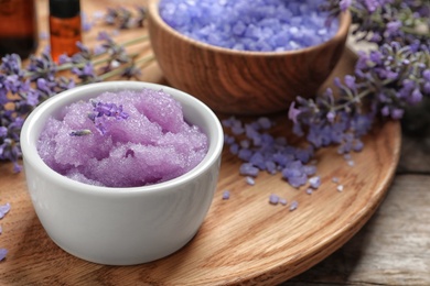 Photo of Composition with natural sugar scrub and lavender flowers on wooden table. Cosmetic products