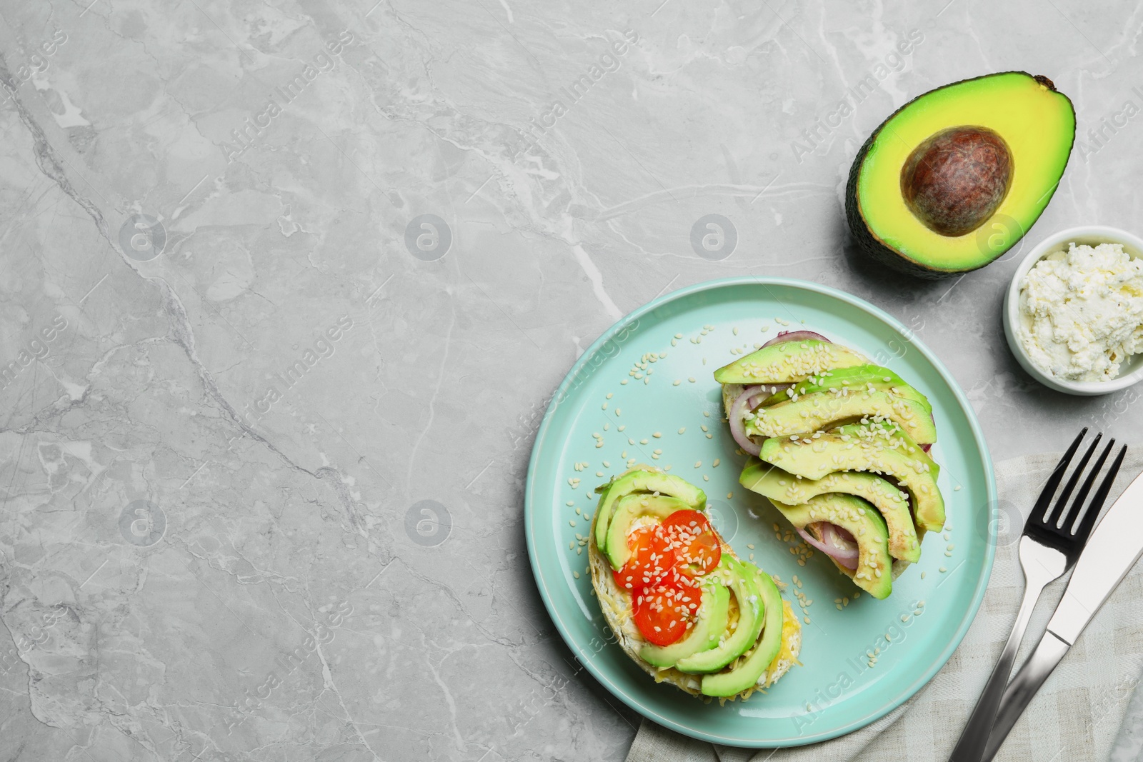 Photo of Flat lay composition with avocado sandwiches on light grey table. Space for text