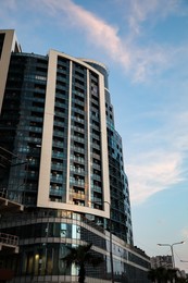 Photo of Beautiful skyscraper on city street in evening