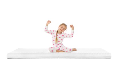 Little girl waking up on mattress against white background
